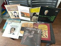 Collection of 9 vinyl records with classical music album covers laid out and stacked showing various composers and artists.