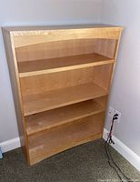 Front view of the Tradewins birch wood bookcase showing three shelves and natural wood grain finish.
