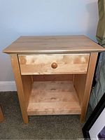 Front view of one Tradewins birch nightstand showing single drawer and open shelf