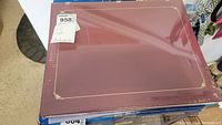 Photo of the maroon Creative Memories scrapbooking album with gold decorative corners.