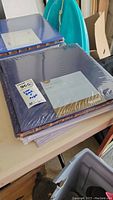 Stack of two blue Creative Memories 12x12 Flex Hinge scrapbooking albums sealed in plastic, stacked on a table.