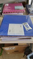 Shows a blue Creative Memories Flex-Hinge scrapbooking album sealed in plastic, with an informational sticker on the front cover.
