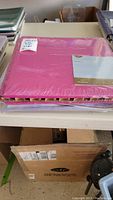 Side view photo of the pink scrapbook album showing spine and book thickness.