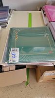 Green Creative Memories 12x12 album sealed in plastic wrap with label noting scrapbook and pages