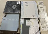 Top view of album with decorative pages and sheet protectors neatly stacked beside it.