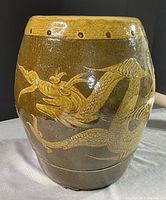 Full view of barrel showing four-toed dragon motif on glazed ceramic surface with yellow rim.
