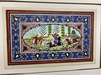 Front view of the framed Middle Eastern primitive hunting scene painting showing the detailed hunting scene with riders on horseback and decorative border.