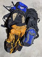 Overall view of six backpacks, showing variety and color.