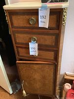 Front view of wooden side cabinet showing two drawers, open cabinet door, marble top, brass pulls and ormolu accents