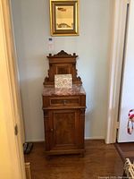 Front view of entire lot: cabinet with marble top, mirror above, box on top