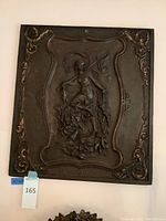 Full front view of metal plaque mounted on wall