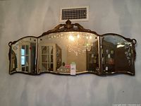 Front view showing entire mirror hung on wall