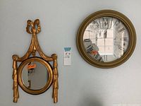 Mirror and clock hung on a wall, showing size and style of both items.