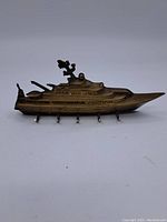 Front angled view of the brass ship key holder showing five hooks and detailed ship design.
