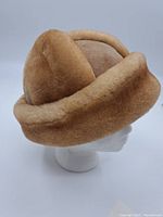 Side view of vintage fur and suede hat showing the tan fur trim and suede body.