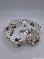 Photo of the serving tray showing the 3 connected compartments with floral violet pattern and gold trim.