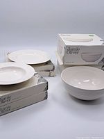 Full view of all dishes arranged with their boxes, showing bowls and plates, all Jamie Oliver branded.