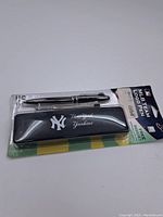 Front view of the pen set packaging showing two metallic silver pens and a black case with New York Yankees logo and name.