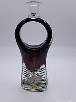 Front view of the crystal candle holder showing the circular loop design and the clear glass candle cup on top.