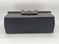 Side view of black textured medical bag showing rectangular shape and overall condition.