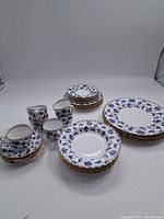 Overall view of dinner plates, smaller plates, cups, and saucers showing the full set and pattern details