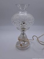 Full Waterford crystal lamp base with removable shade detached, showing cord wrapped around base and bulb holder