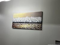 Photo showing full view of rectangular painted artwork hung on wall with white tree design and abstract colored foreground.