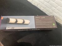 Boxed Allen + Roth Kinsley 3-light brushed nickel LED vanity light bar, showing front of retail packaging with product image and details.