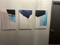 Set of three abstract canvas art pieces hanging on a white wall, showing the overall layout and relationship of the pieces.