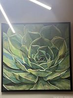 Front view of large green succulent flower artwork in black frame showing overall design and colors.