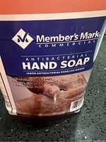 Front label showing the branded antibacterial hand soap with claims of killing 99.9% of germs, fresh clean fragrance and triclosan free.