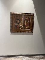 Full view of the framed modern abstract artwork hanging on a wall.
