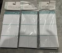 Three individually packaged magnetic list pads, shown front-facing, displaying the list sections and magnetic backing mention on packaging.