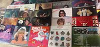 Large collection of vinyl albums overview, showing colorful cover art of various artists including Christmas and folk themed albums.