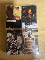 Top view showing front covers of four audio cassette tapes by Van Morrison, Soundgarden, Violent Femmes, and Cracker.