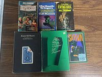 Front view of all six Dell Shannon books showing covers and titles.