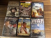 Front view of the six sealed military history DVDs showing cover art and title.