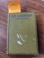 Front cover of vintage book 'The Lookout Man' showing the title, author, and signed copy label with wear and scuff marks on cover