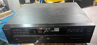 Front angled view of black Sony CDP-C235 showing display and control panel of 5-disc CD player