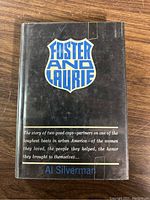 Front cover of the book Foster and Laurie with author name Al Silverman and blue, white text on black background.