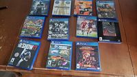 Photo showing all 11 PS4 game cases laid out on a table, visible titles include Uncharted collections, NHL 19, Knack, Trackmania Turbo, Psycho-Pass, FIFA 16, Among Us, MLB The Show 17, Rocket League, and Minecraft Dungeons.