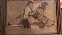 Full view of the signed framed photo showing Turk Broda in goalie gear with net background and signature.