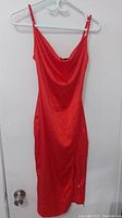 Front view of CBR women's red dress hanging on a white hanger showing the V-neckline and fitted silhouette.