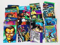 Spider-Man trading cards fanned out in multiple rows showing front card faces with varied colorful comic illustrations.