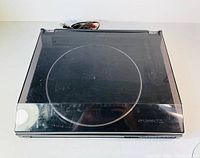 Top view with clear plastic dust cover lid attached, showing scratches on the dust cover.