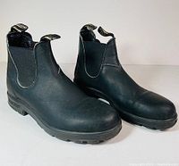 Front angled view of both black Blundstone Chelsea boots showing leather upper, elastic gores and pull tabs.