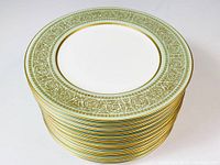 Stack of 12 Mikasa Rosemont #117 dessert plates showing the mint green and gold leaf pattern on rims.