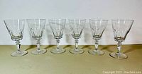 Front view of 6 vintage Val Saint Lambert crystal stemmed glasses arranged in a row showing their shape and style