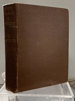 Brown cloth hardcover book titled 'Seven Pillars of Wisdom' by T.E. Lawrence with visible wear and gilt lettering on spine.