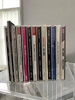 Row of thirteen Bill Evans CD spines on clear display stand